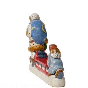 White Father Christmas and Angel Pushing Sled