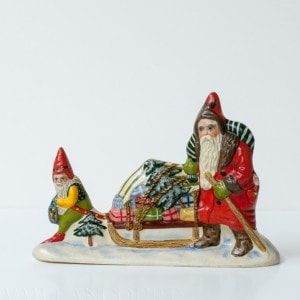 Gnome Pulling Sled of Gifts with Father Christmas