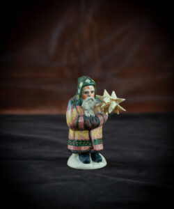 9th Annual Starlight Santa Holding Hand-Folded Paper Moravian Star