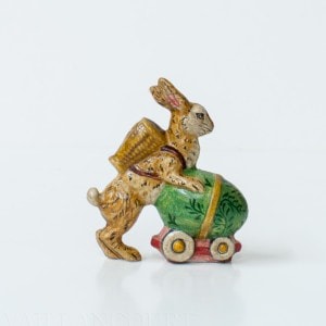 Rabbit Pushing Egg on Wheels
