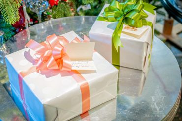 Gift-Wrapped Gifts For Every Occasion Two gifts, beautifully gift wrapped in white paper. One box with a beautiful green ribbon and bow and the second in pink. Displaying a hand-written gift tag with a personalized message for the gift recipient.