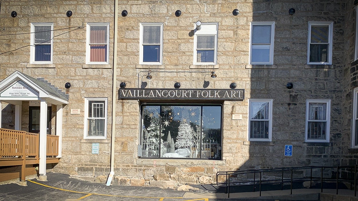 Vaillancourt Folk Art's picture window looking into their retail gallery in Sutton, MA.