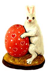 Rabbit holding heart egg
