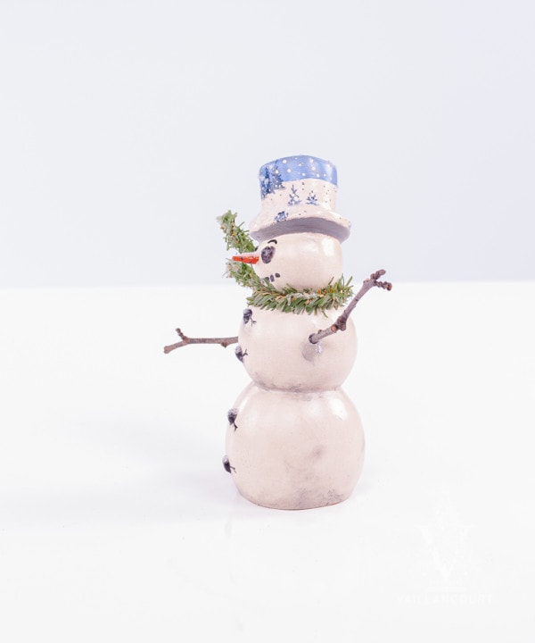 Wind Blown Snowman with Stick Arms And Blue Winter Hat
